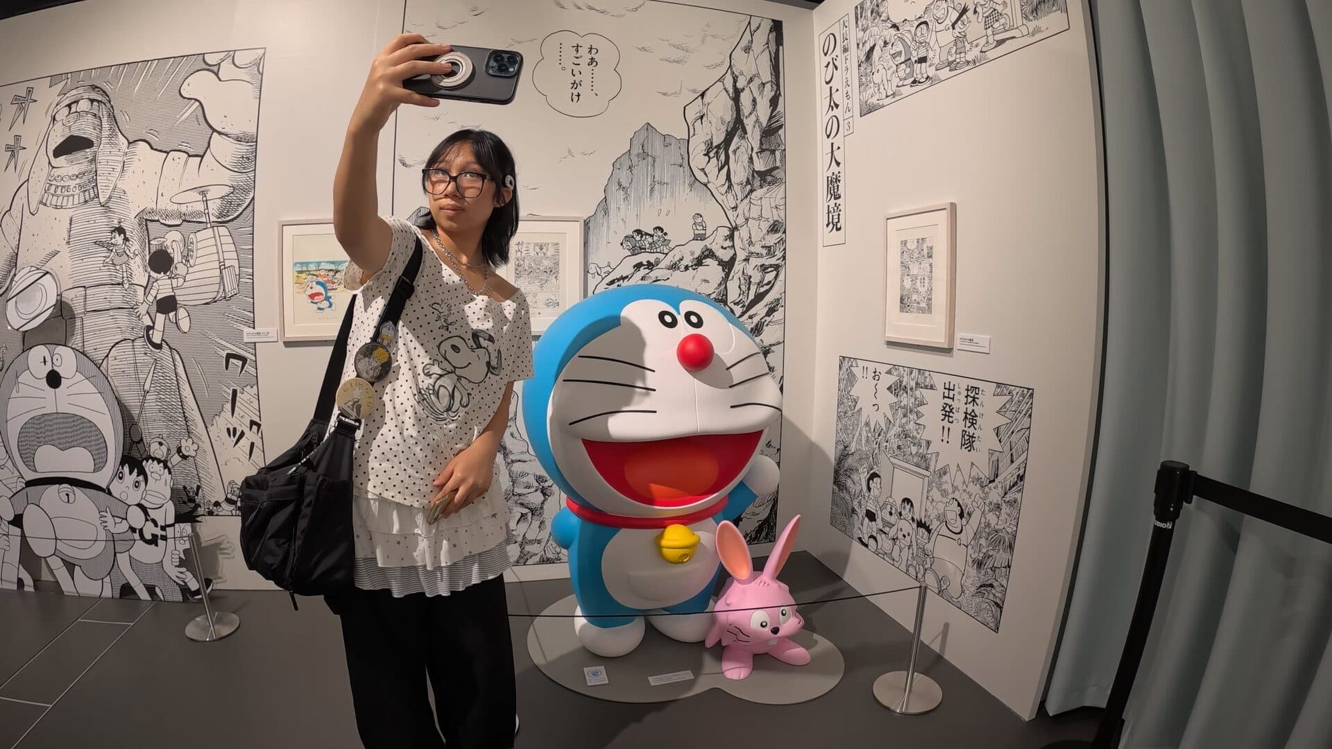 Us with Doraemon and the small pink rabbit, manga panels behind.
